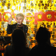 A man with frosted tips sings to a silhouetted audience with the MoviePass logo in the background.